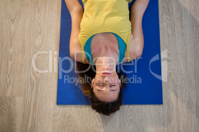 Woman doing meditation on exercise mat