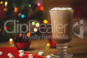 Cup of coffee with marshmallow on wooden table