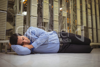 Tried technician sleeping on tiled floor