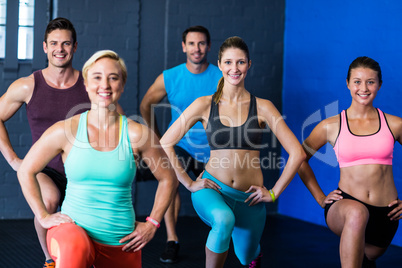 Smiling male and female athletes exercising