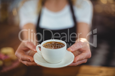 Waitress offering a cup of coffee