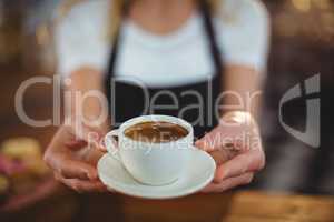 Waitress offering a cup of coffee