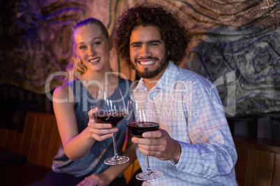 Couple holding a glass of wine in bar