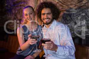 Couple holding a glass of wine in bar