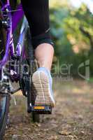 Female cyclist cycling in countryside