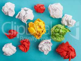 Colorful crumpled paper on blue