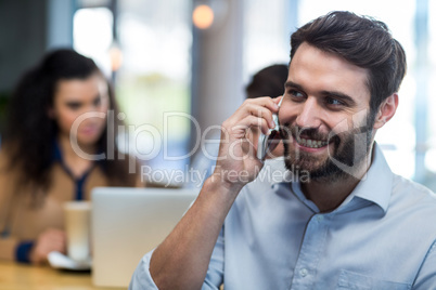 Smiling man talking on mobile phone