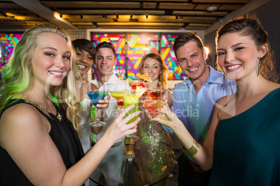 Group of friends toasting glass of cocktail in bar