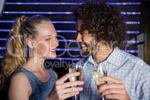 Couple toasting glass of champagne in bar