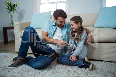 Father and daughter interacting with each other in the living room