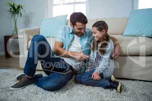 Father and daughter interacting with each other in the living room