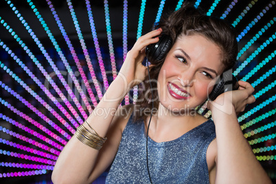 Pretty female DJ playing music