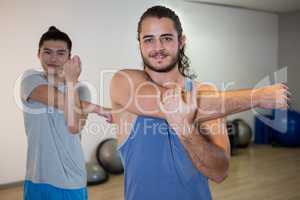 Smiling two men doing aerobic exercise