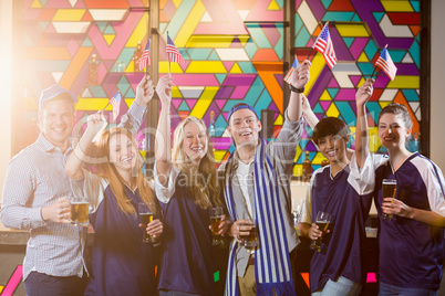 Group of friends holding american flag in party