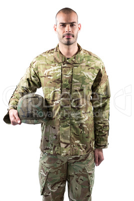 Portrait of confident soldier standing with a helmet