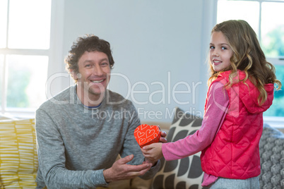 Daughter giving present to her father