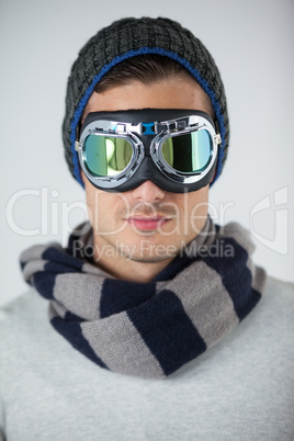 Man in winter clothing wearing aviator goggles