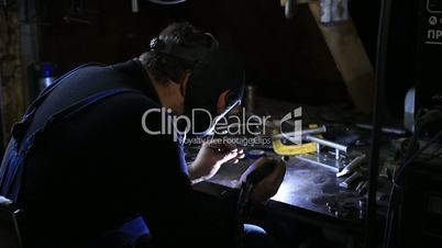 Closeup of man wearing mask welding in workshop