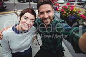 Couple posing for selfie in cafeteria