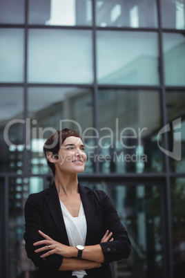Smiling businesswoman standing in office premises