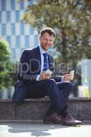 Portrait of handsome businessman having snacks