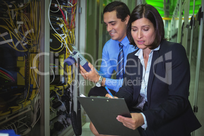 Technicians analyzing rack mounted server