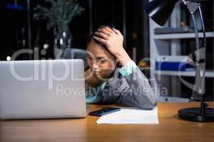 Tired businesswoman sleeping on the desk