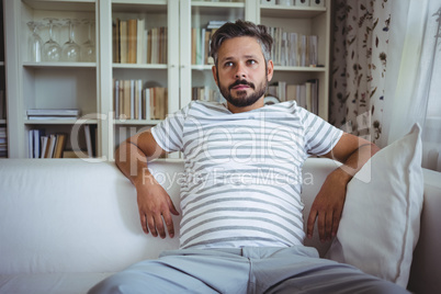 Man sitting on sofa in living room