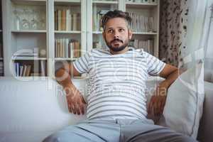 Man sitting on sofa in living room