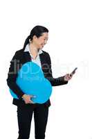 Smiling businesswoman using mobile phone against white background