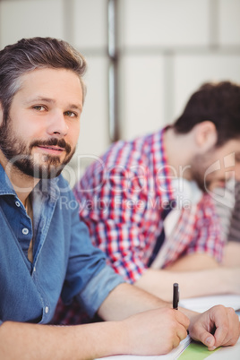 Close-up of handsome executive with colleague at creative office