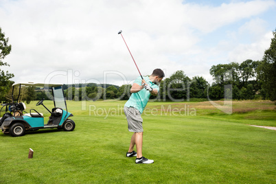 Focused man playing golf