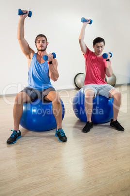 Men exercising on exercise ball