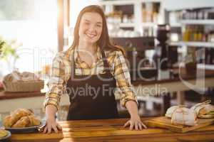 Portrait of waitress standing behind the counter