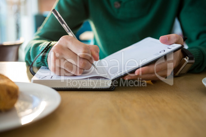 Man writing in diary