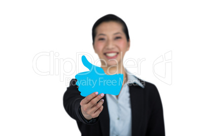 Portrait of businesswoman showing thumbs up sign board