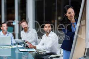 Businesswoman writing on whiteboard