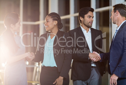 Group of businesspeople shaking hands with each other