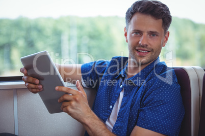 Portrait of handsome man using digital tablet