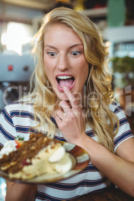 Woman holding a plate of desserts