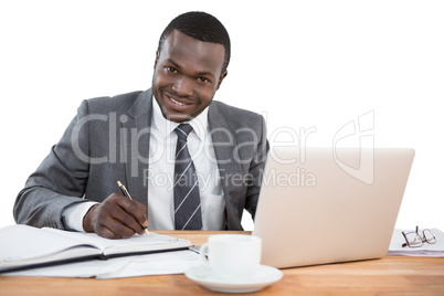 Happy businessman working at office desk