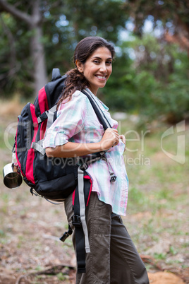 Female hiker standing in forest