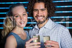 Couple holding glass of champagne in bar