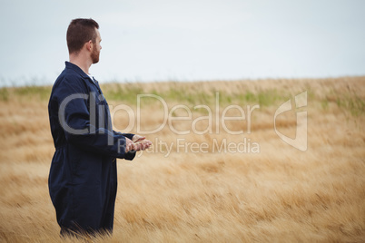 Farmer standing in field and looking view