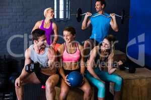 Happy athletes with exercise equipment