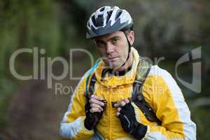 Close-up of serious male biker in forest