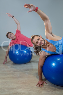 Men exercising with exercise ball