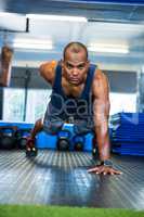 Serious male athlete doing push-ups