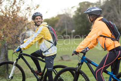 Biker couple interacting while cycling