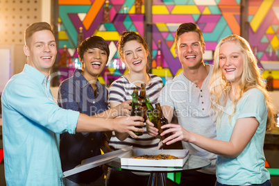 Group of friends toasting bottle of beer